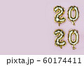 New Year 2020. Vertical composition of number 2020 golden foil balloons on pastel pink background 60174411