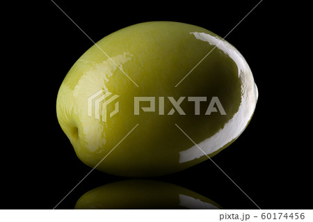 Macro photo of green olive with reflection of light isolated on a black Macro photo of green olive with reflection of light isolated on a black 60174456