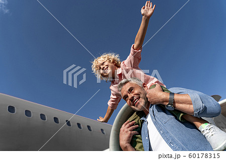 Happy little son and his father playing together Happy little son and his father playing together 60178315