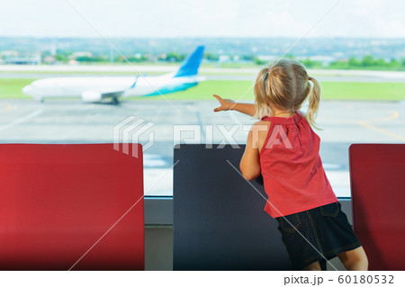 Little kid wait for boarding to plane flight in Little kid wait for boarding to plane flight in 60180532