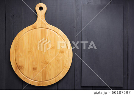 pizza cutting board at rustic wooden plank 60187597