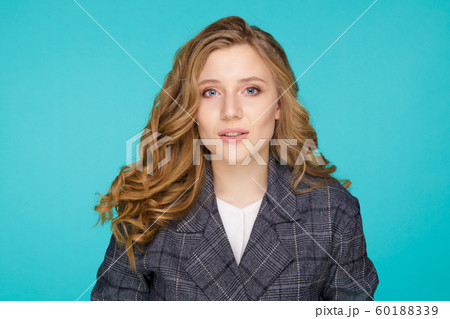 Closeup portrait of pretty yong woman with bright makeup in a studio isolated over the blue background. 60188339