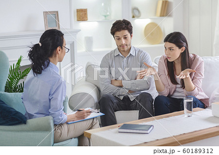 Furious wife complaining about her husband to family therapist Furious wife complaining about her husband to family therapist 60189312