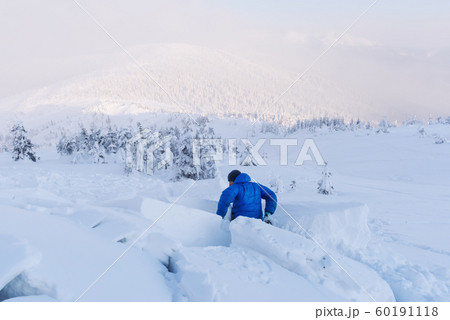 A man covered with a snow avalanche 60191118