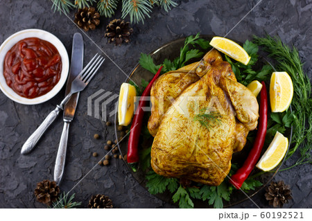 Fried whole chicken on a platter. Holiday lunch. Fried whole chicken on a platter. Holiday lunch. 60192521