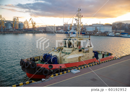 A tug of a ship stands moored at the pier on a A tug of a ship stands moored at the pier on a 60192952