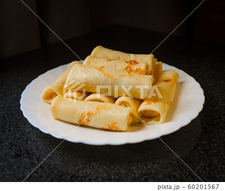 Rolled pancakes on a plate 60201567