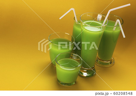 Glass of green juice with copy space for text, fresh apple and celery cocktail Glass of green juice with copy space for text, fresh apple and celery cocktail 60208548