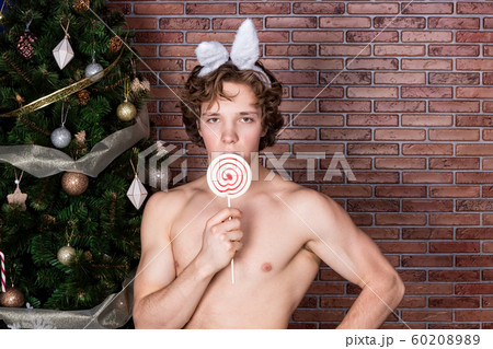 Handsome naked guy in suit rabbit celebrating 60208989