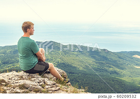 Young man practicing yoga pose sitting on the Young man practicing yoga pose sitting on the 60209532