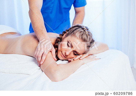 girl masseur doing massage in spa health 60209786