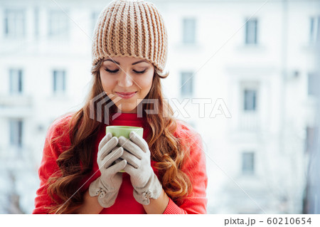 the girl in the hat froze and drinking hot tea the girl in the hat froze and drinking hot tea 60210654