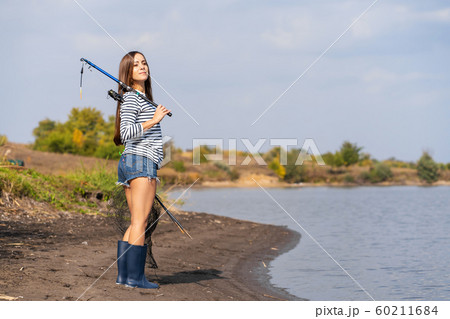 A beautiful young girl goes fishing. A girl with a 60211684