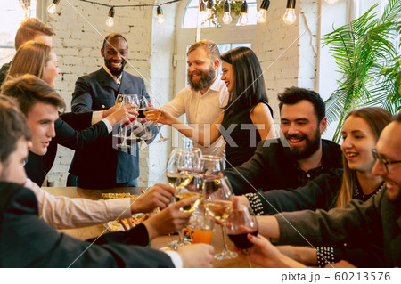 Happy co-workers celebrating while company party and corporate event Happy co-workers celebrating while company party and corporate event 60213576