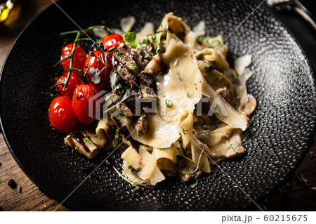Black Angus Pasta served in a black bowl in restaurant 60215675