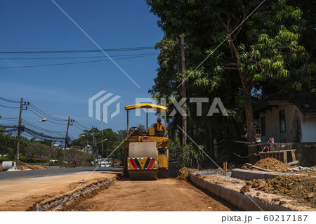 Road rollers working on the new roads construction site. Heavy duty machinery working on highway. Construction equipment. Compaction of the road. 60217187