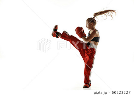 Young female kickboxing fighter training isolated on white background Young female kickboxing fighter training isolated on white background 60223227