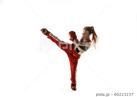 Young female kickboxing fighter training isolated on white background Young female kickboxing fighter training isolated on white background 60223237