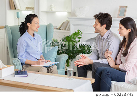 Family therapist giving advices young married couple 60223745