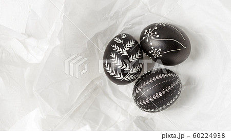 Pysanky on the white crumpled paper background 60224938