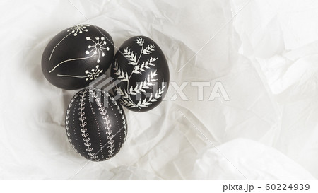 Pysanky on the white crumpled paper background 60224939