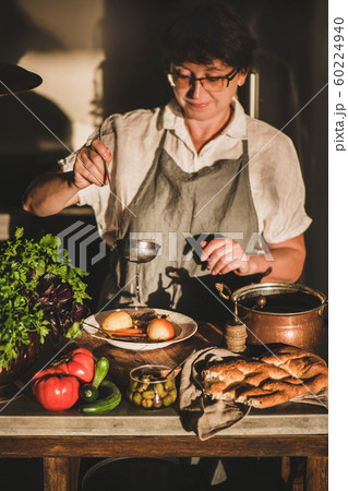 Woman cooking Turkish traditional meat soup 60224940