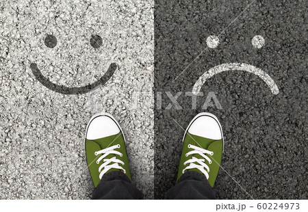 Smiles drawn on asphalt road, pros and cons 60224973