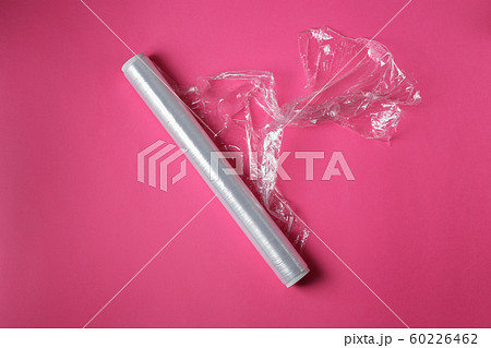 Wrapping plastic stretch film on pink background 60226462