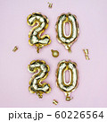 Happy New year 2020 celebration concept. Gold foil balloons numeral 2020 and golden stars on pastel 60226564