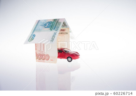 toy red car in the garage made of banknotes. real 60226714