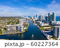 Aerial view of boat on Miami Beach canal with a flock of crows 60227364
