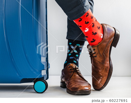 Stylish suitcase, men's legs and bright socks 60227691