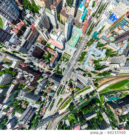 Aerial city view with crossroads and roads, houses, buildings, parks and parking lots. Sunny summer Aerial city view with crossroads and roads, houses, buildings, parks and parking lots. Sunny summer 60235500