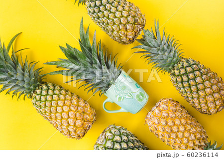 Fresh pineapple on the yellow background 60236114