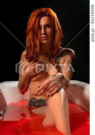 Red-haired nude woman in bloody bath shot Red-haired nude woman in bloody bath shot 60238398