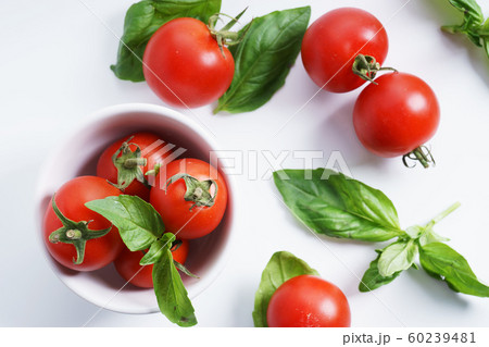 red ripe tomatoes and basil leaves 60239481