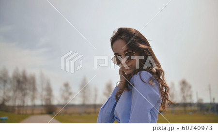 Beautiful 17 year old girl posing outdoors against the blue sky. 60240973