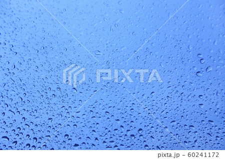 Water drops on glass, natural blue texture 60241172