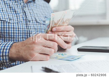 Businessman calculates the costs incurred or salary 60242906