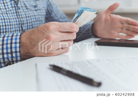 Tough financial conditions. Businessman holds money and gestures specifically Tough financial conditions. Businessman holds money and gestures specifically 60242908