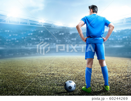 Rear view of Asian football player man standing with the ball Rear view of Asian football player man standing with the ball 60244269