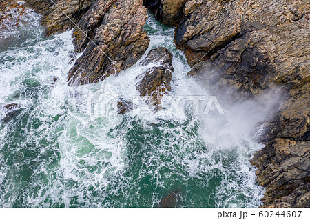 Atlantic waves splash against the rock at the Donegal coast in Ireland 60244607