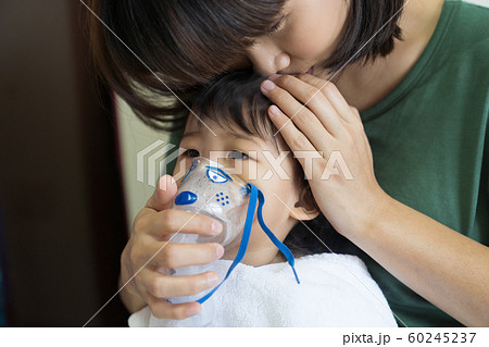 Asian baby girl breathing treatment with mother 60245237