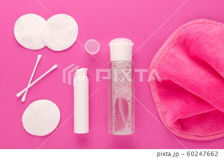 make up remove products, micellar water, face cleaning cloth, cleansing milk and cotton pads on pink background 60247662