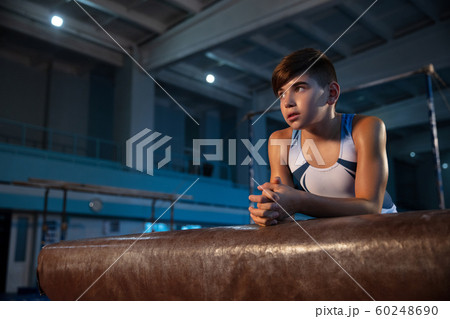 Little male gymnast training in gym, flexible and active 60248690
