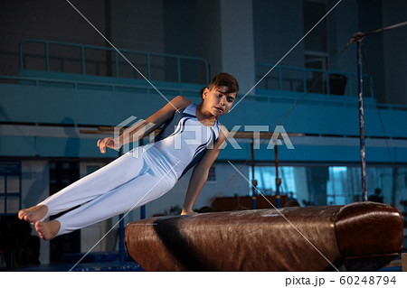 Little male gymnast training in gym, flexible and active Little male gymnast training in gym, flexible and active 60248794