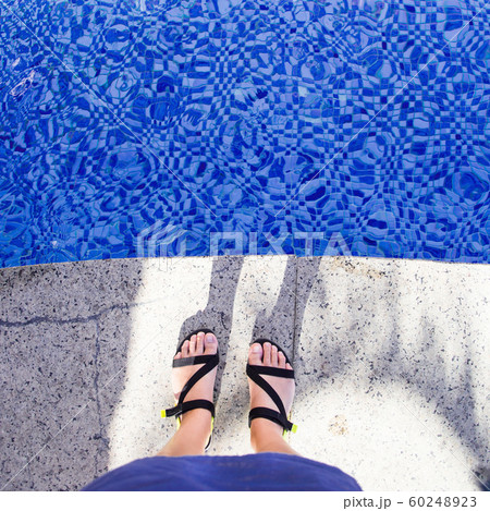 Blue colored mosaic pool and female legs in Blue colored mosaic pool and female legs in 60248923