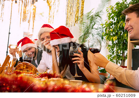 Happy co-workers celebrating while company party for New Year and Christmas 60251009