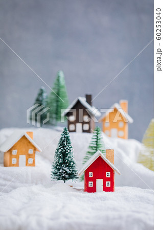 Miniature wooden houses on the snow over blurred Miniature wooden houses on the snow over blurred 60253040