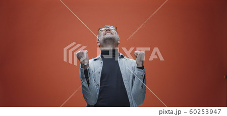 Delighted man celebrating success Delighted man celebrating success 60253947